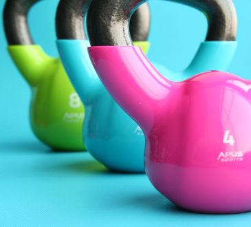 Colourful kettle bells on blue background