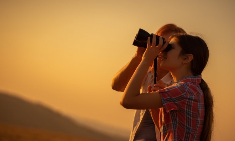 Young woman using binoculars