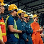 Workers wearing hard hats in industrial setting