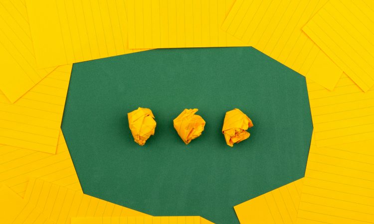 Green speech bubble on yellow background