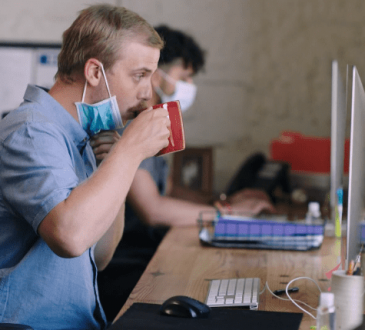 Person drinking coffee in co-working space
