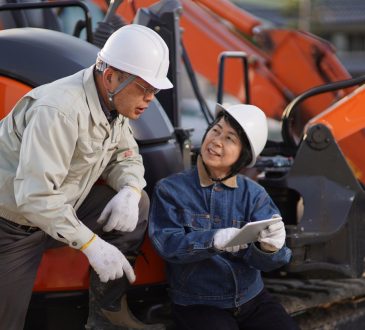Two workers talking at a construction site