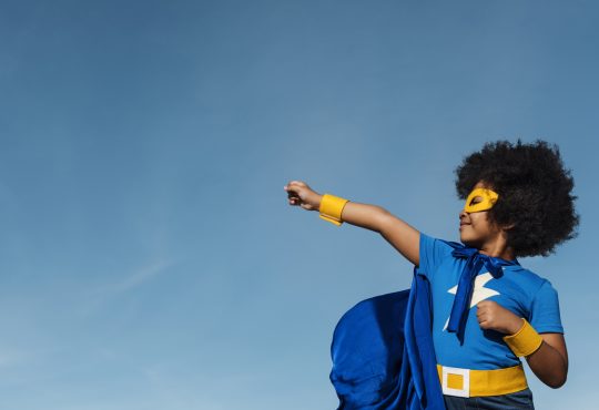 Kid wearing superhero costume