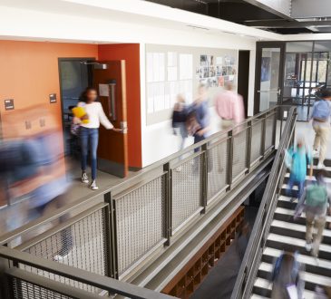 Blurred photo of people walking through hallway in school