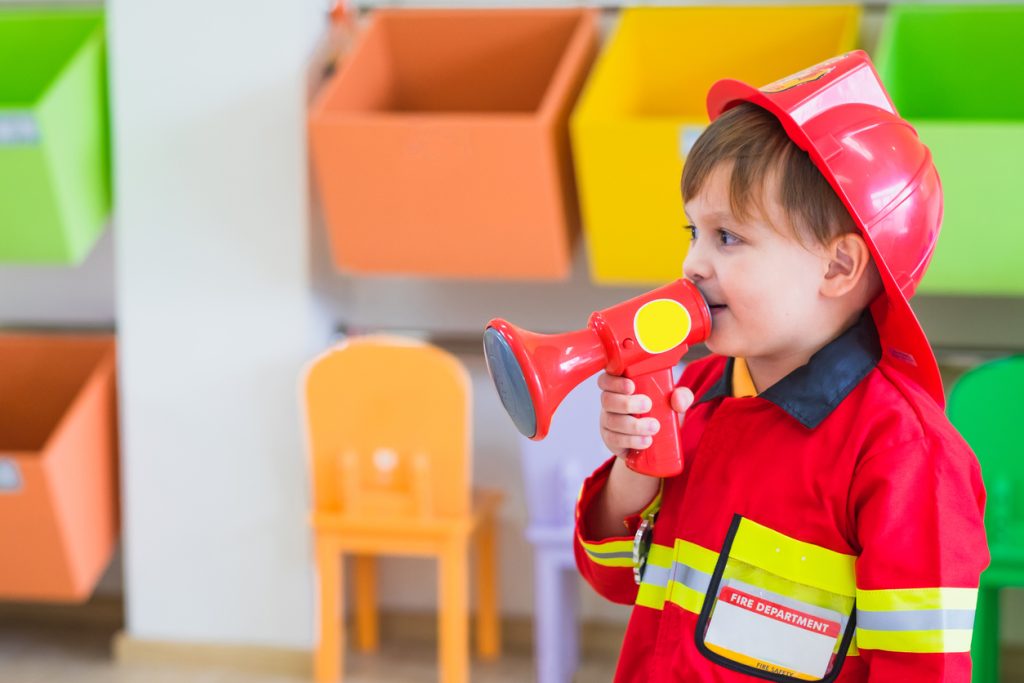 Little boy wearing fireman costume