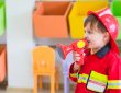 Little boy wearing fireman costume