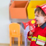 Little boy wearing fireman costume