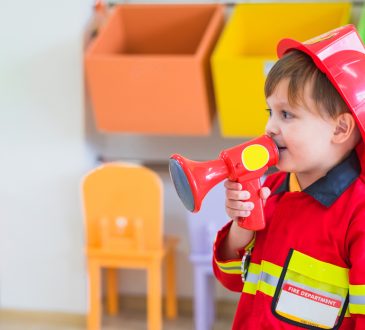 Little boy wearing fireman costume