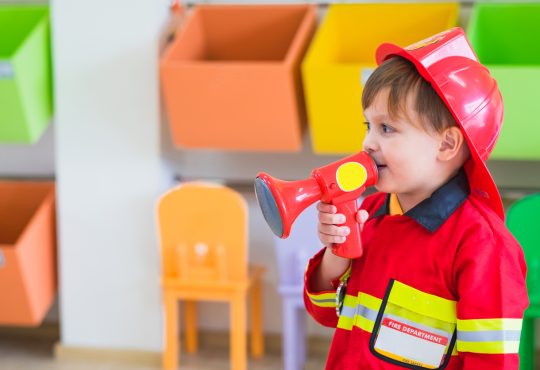 Little boy wearing fireman costume