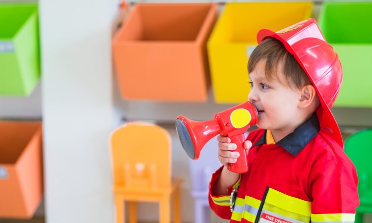 Little boy wearing fireman costume