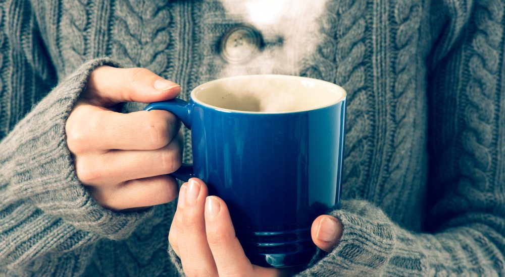 Woman holding mug of hot tea