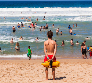 Lifeguard looking at people swimming at beach