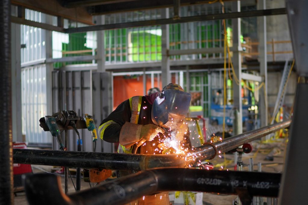 Person welding on construction site