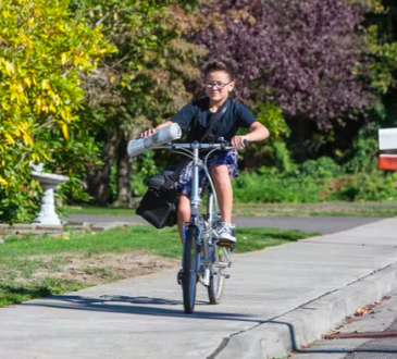Boy delivering newspapers on bike