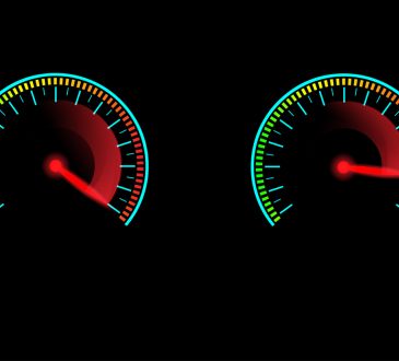 Speed meter with red gauge needle glowing in the dark