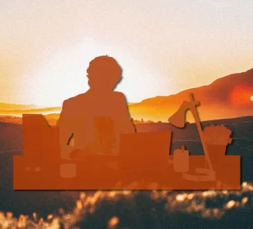 Copper coloured silouhette of a short-haired individual writing and sitting behind a stack of books. The silhouette is on top of a sunset image.