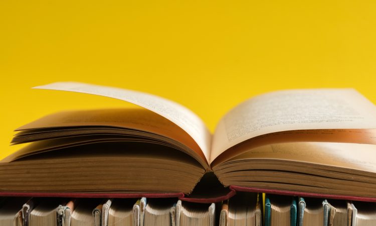 Open book on yellow background