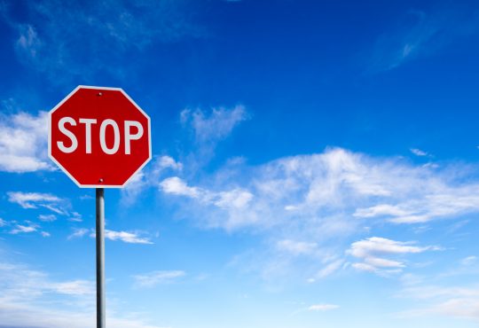 stop sign with blue sky background