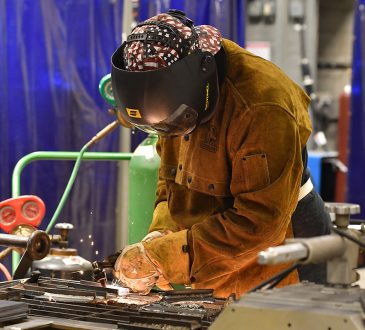 Student welding in workshop.