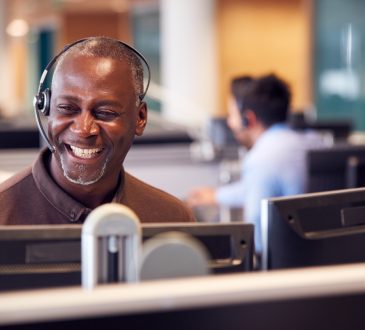 Man wearing headset at desk talking on call