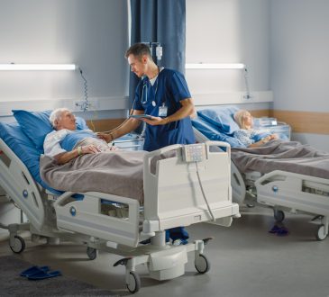 Nurses helping patients in hospital ward