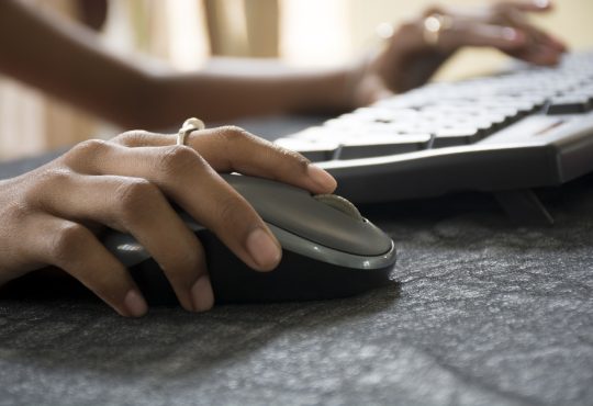 Woman hand with Computer Mouse close up