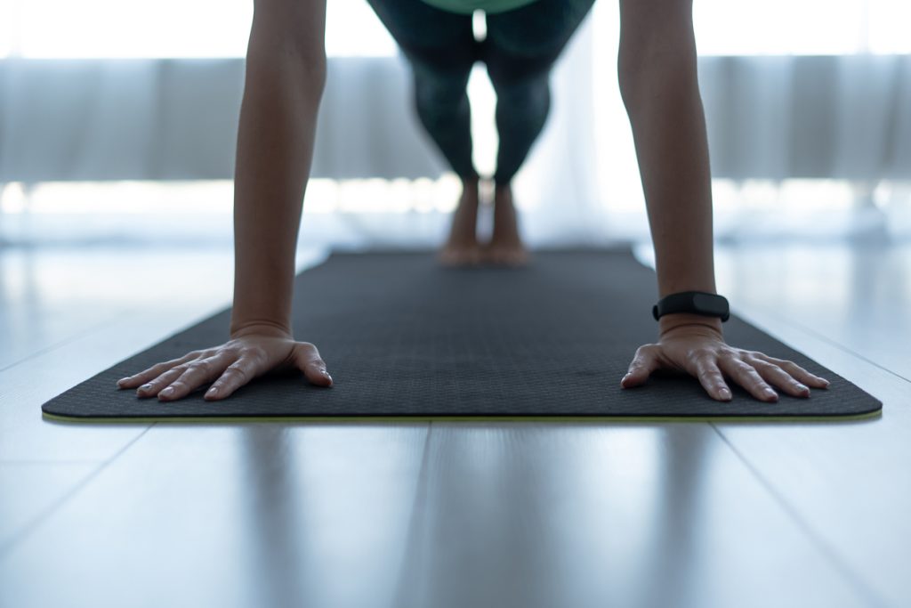 Person in plank pose on yoga mat