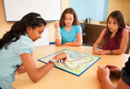 Students in a classroom playing an educational game