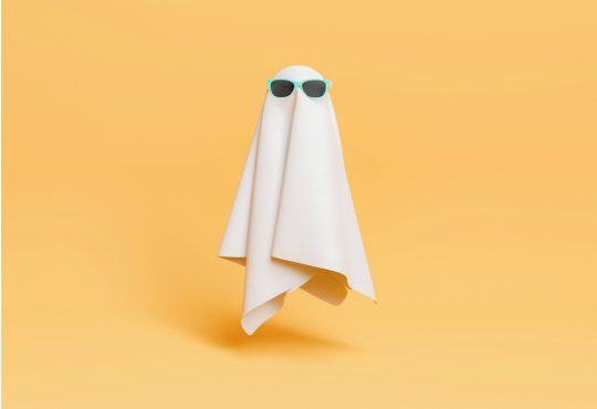 Ghost wearing sunglasses floating on yellow background