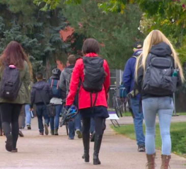 Students walking on campus outside.
