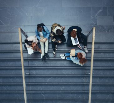 University students sitting on steps on campus