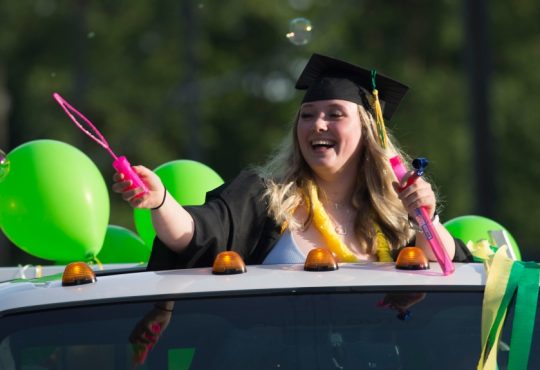 High school graduates from Windsor Secondary in North Vancouver, B.C. take part in a graduation parade.