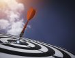 Dart board against blue sky