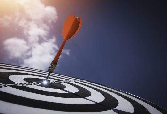 Dart board against blue sky