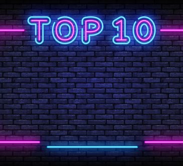 Neon sign reading Top 10 on brick wall