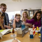 Middle school teacher and students conducting scientific experiment