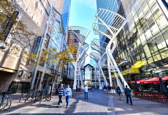 Pedestrians walking past retail outlets along Stephen Ave in Autumn in Calgary.
