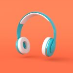 Teal over-ear headphones on orange background