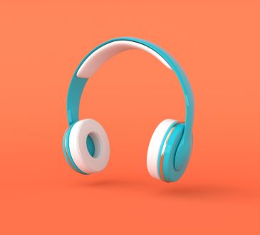 Teal over-ear headphones on orange background