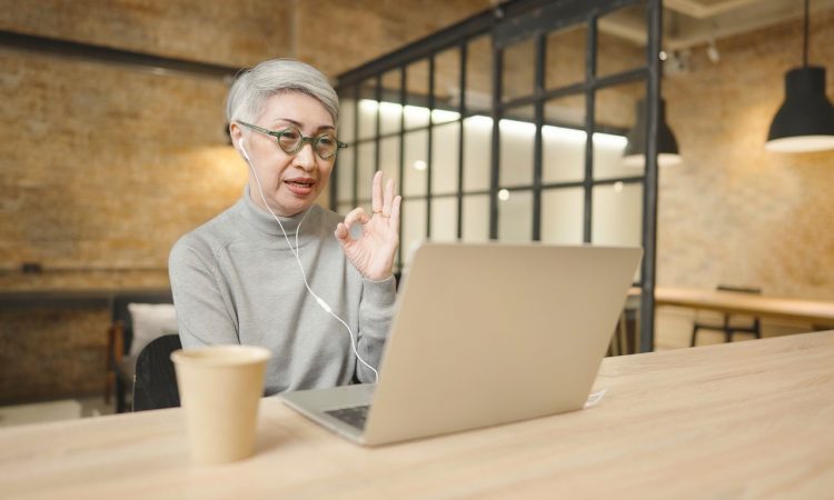 Woman on video call on laptop in office