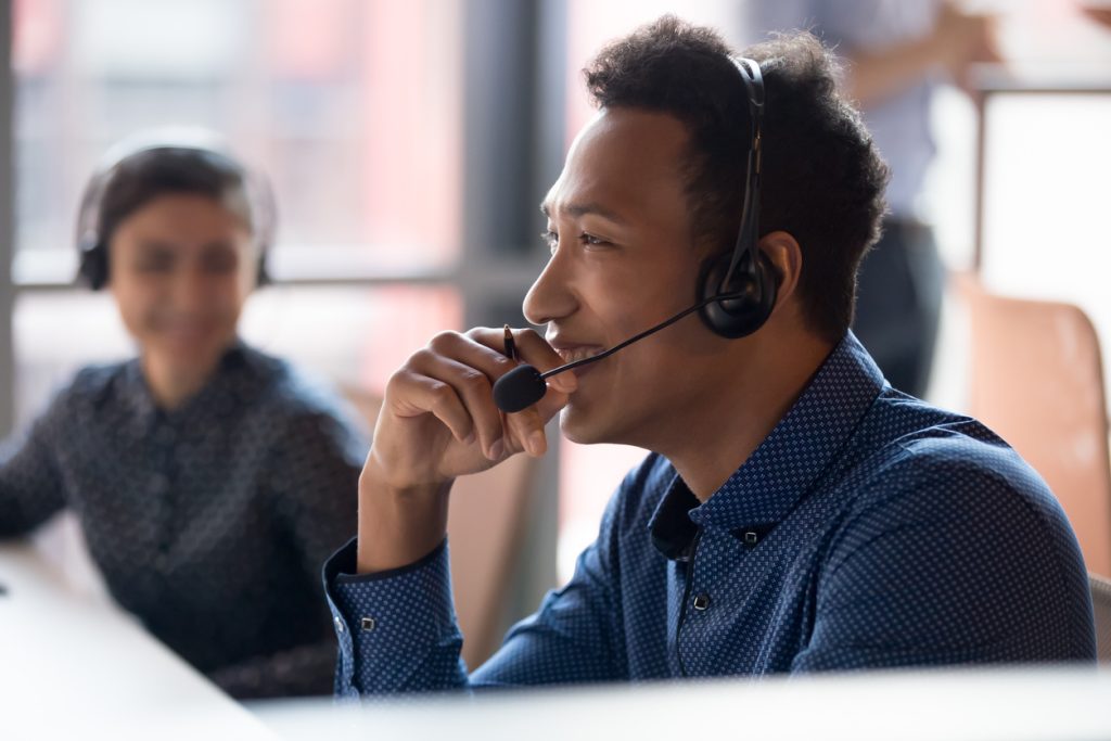 Smiling man working in call centre