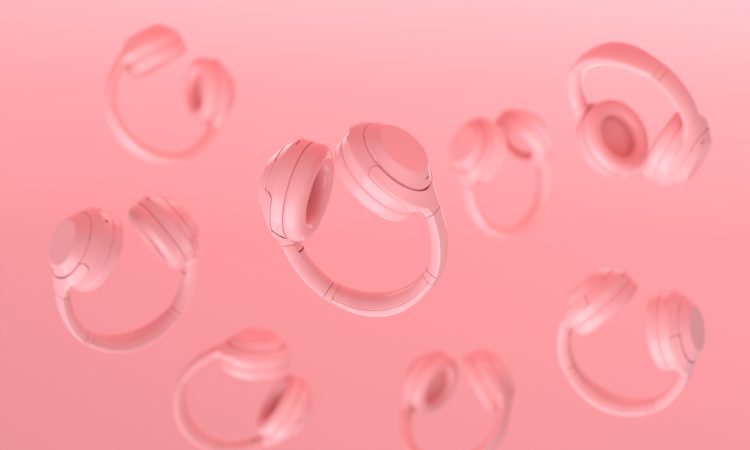 Floating headphones on pink background