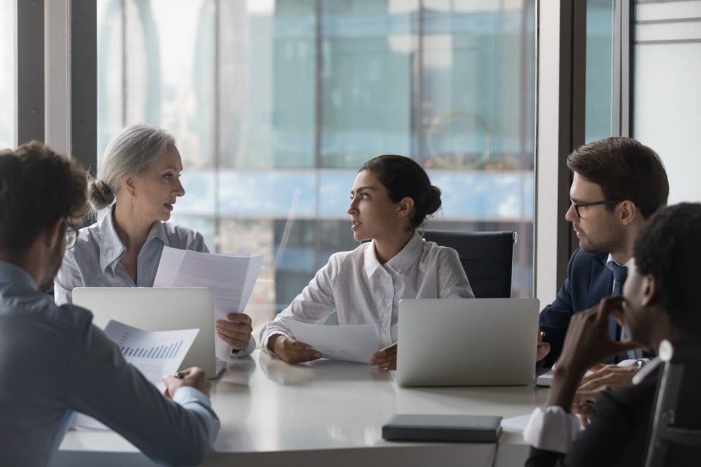 Staff members at boardroom table