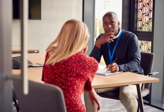 Man and woman sitting at table talking