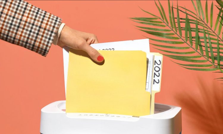 Person shredding file folder