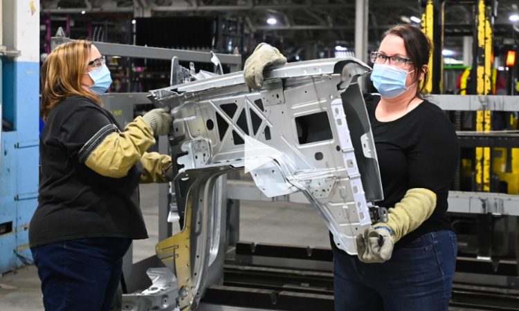 Two women working in car factory