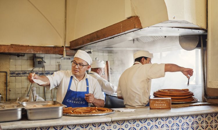 Two men cooking in restaurant kitchen