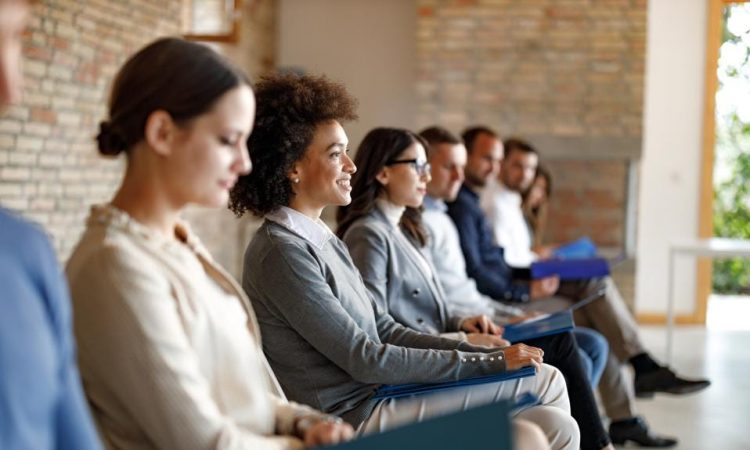 People sitting waiting to be called in for job interview