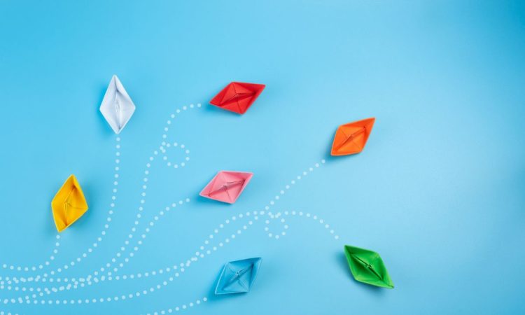 Paper boats on blue background