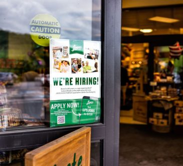 Hiring sign in grocery store window